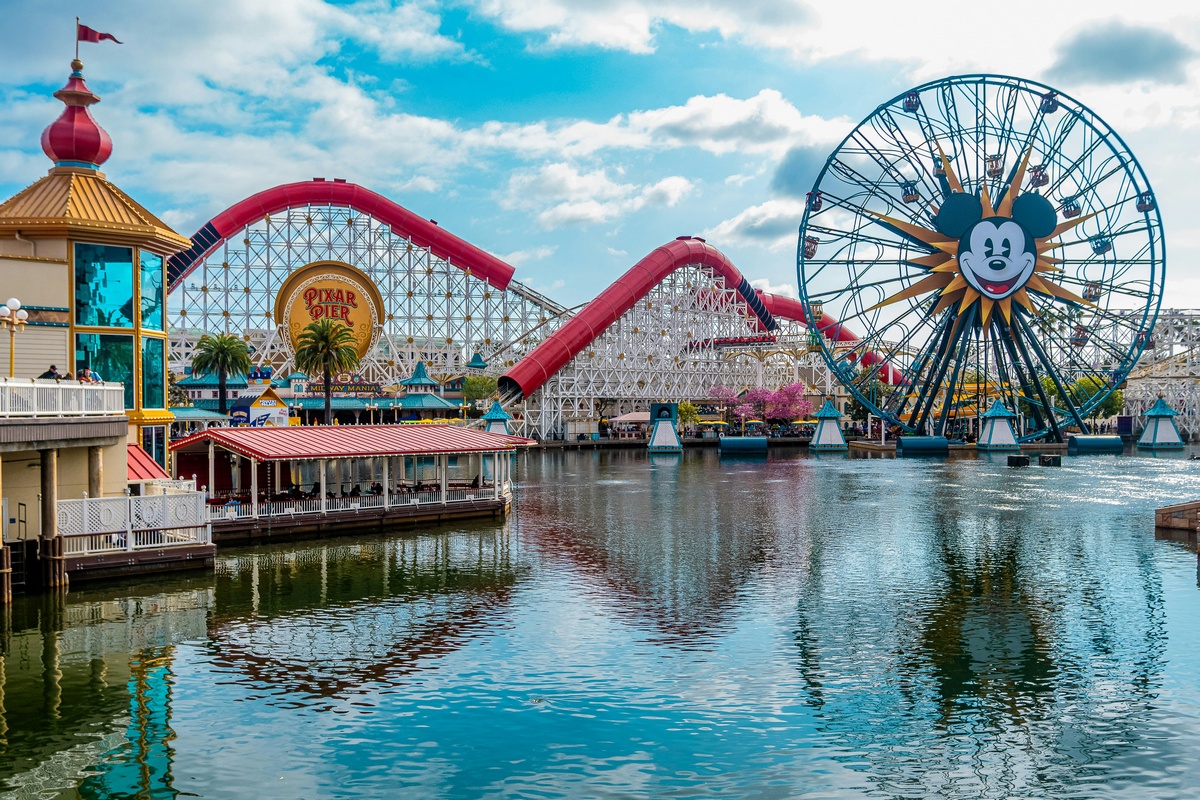 disney-california-adventure-family-travel Mickey Mouse Ferris wheel and roller coaster overlooking the lagoon at Pixar Pier Disneyland California